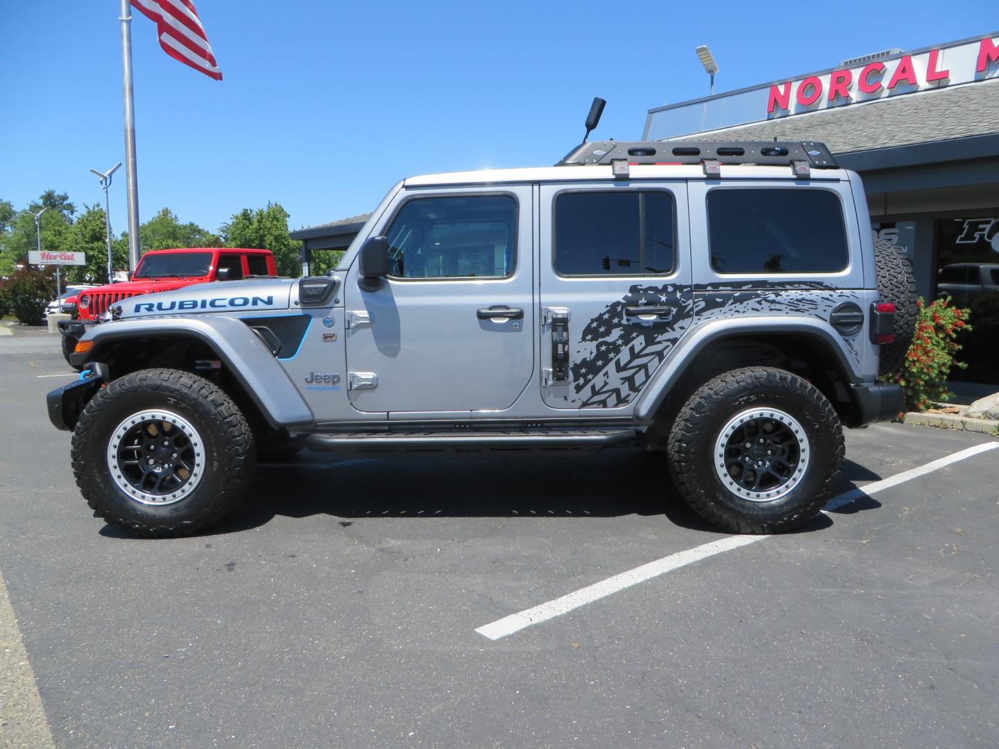 2021 SILVER /BLACK Jeep Wrangler Unlimited Rubicon 4XE 4d SUV 4wd (1C4JJXR63MW) with an 2.0L L4 DOHC 16V TURBO engine, automatic transmission, located at 2630 Grass Valley Highway, Auburn, CA, 95603, (530) 508-5100, 38.937893, -121.095482 - Impressive 4xe Rubicon with a ton of extras that include Fox 3.0 internal bypass front and rear shocks, 315 BFG KO2 tires, Warn winch, Factor 55 Ultra hook, Front bumper stinger, Rigid Pods on front bumper, Rigid A series lights in the roof rack, DV8 lockable hood pins, Westin Running boards, Fury d - Photo#7